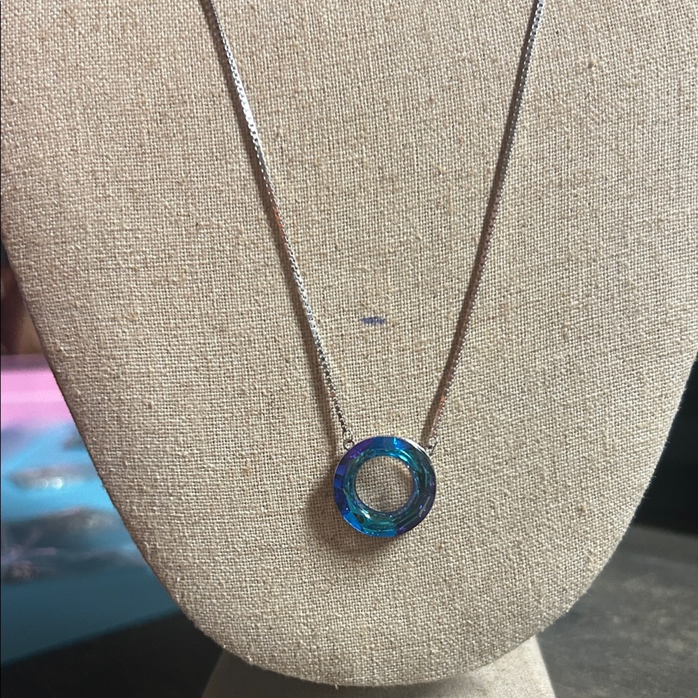 sterling silver necklace features a blue Austrian‎ crystal wishing ring pendant